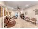 Comfortable living room features tile flooring, ceiling fan, and a sliding door at 2522 Darda St, Henderson, NV 89044