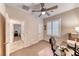 Office/bedroom featuring neutral carpeting, a ceiling fan, and plantation shutters at 2522 Darda St, Henderson, NV 89044
