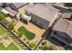 Aerial view of a backyard with artificial turf, landscaping, and an attractive two-story home at 2575 Hazelburn Ave, Henderson, NV 89044