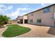 Expansive backyard showing artificial turf and rock landscaping, with a covered patio and attractive architecture at 2575 Hazelburn Ave, Henderson, NV 89044