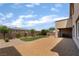 View of a well-maintained backyard featuring a patch of green turf, landscaping, and covered patio at 2575 Hazelburn Ave, Henderson, NV 89044