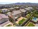 Aerial view of backyard with turf and desert landscaping, including view of community pool at 2575 Hazelburn Ave, Henderson, NV 89044
