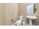 Charming powder room with pedestal sink and decorative mirror at 2575 Hazelburn Ave, Henderson, NV 89044