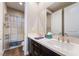 Bathroom features a double sink vanity and shower-tub combo with modern fixtures at 2575 Hazelburn Ave, Henderson, NV 89044