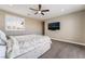 Bedroom with a ceiling fan, large window, and TV mounted on the wall at 2575 Hazelburn Ave, Henderson, NV 89044