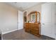 Bedroom featuring a wooden dresser, multiple doors and neutral carpeting at 2575 Hazelburn Ave, Henderson, NV 89044