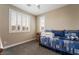 Comfortable bedroom featuring shuttered windows and a cozy daybed with a blue pattern at 2575 Hazelburn Ave, Henderson, NV 89044