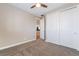Well-lit bedroom features plush carpeting, a ceiling fan and an adjoining room view at 2575 Hazelburn Ave, Henderson, NV 89044