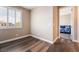 Empty bedroom features a view to a window, wood floors, and entry to another bedroom at 2575 Hazelburn Ave, Henderson, NV 89044