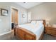 Inviting bedroom features a wood frame bed, carpet, and ensuite bathroom for convenience at 2575 Hazelburn Ave, Henderson, NV 89044