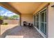 Covered patio featuring brick pavers, a stainless steel grill, outdoor furniture, and sliding glass doors to the house at 2575 Hazelburn Ave, Henderson, NV 89044