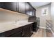 Spacious laundry room with modern washer and dryer, storage cabinets, and a utility sink at 2575 Hazelburn Ave, Henderson, NV 89044