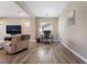 Spacious living room with hardwood floors, neutral paint, and a comfortable recliner at 2575 Hazelburn Ave, Henderson, NV 89044