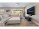 Open living room with sliding doors, a comfortable couch, and hardwood floors at 2575 Hazelburn Ave, Henderson, NV 89044