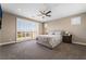 Spacious main bedroom with a ceiling fan, carpet, shutters, and access to balcony at 2575 Hazelburn Ave, Henderson, NV 89044