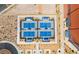 Aerial view of four pickleball courts with blue surfaces and covered benches in a well-maintained community setting at 2575 Hazelburn Ave, Henderson, NV 89044