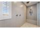 Close-up of a walk-in shower with dual showerheads and bench seating at 2575 Hazelburn Ave, Henderson, NV 89044
