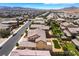 Wide aerial shot shows the street, neighborhood, and meticulously landscaped backyard with desert scape at 2575 Hazelburn Ave, Henderson, NV 89044