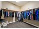 Walk-in closet with ample storage and clothing racks on both sides at 2575 Hazelburn Ave, Henderson, NV 89044