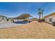 Spacious backyard showing car port and gravel landscaping with desert foliage and palm trees at 2851 Winchester Ave, Pahrump, NV 89048