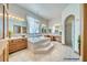 Luxurious bathroom featuring a soaking tub, walk-in shower, and dual vanities at 2851 Winchester Ave, Pahrump, NV 89048