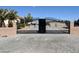 Exterior image showing the decorative driveway gate entrance to the home's gravel-covered yard at 2851 Winchester Ave, Pahrump, NV 89048