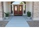Elegant home entrance featuring double doors with glass inserts, flanked by stone columns at 2851 Winchester Ave, Pahrump, NV 89048