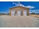 Exterior of the large garage with multiple doors and gravel driveway at 2851 Winchester Ave, Pahrump, NV 89048