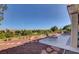 Private outdoor patio with lounge chairs overlooking a golf course and lush landscape at 3032 Highland Falls Dr, Las Vegas, NV 89134