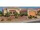 Charming home featuring lush landscaping, a tile roof, and a spacious attached garage at 3032 Highland Falls Dr, Las Vegas, NV 89134