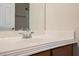Close up of a bathroom sink, faucet, mirror, and wood cabinet, showcasing the updated design at 3312 Speckle Summer Pl # 3, North Las Vegas, NV 89084