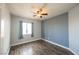 Bright bedroom with a window, wood floors, ceiling fan, and a fresh coat of paint at 3312 Speckle Summer Pl # 3, North Las Vegas, NV 89084