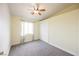Bright, carpeted bedroom with a ceiling fan, closet, and window at 3312 Speckle Summer Pl # 3, North Las Vegas, NV 89084