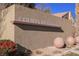 Courts at Aliante entrance with modern signage, desert landscaping, and spherical art pieces at 3312 Speckle Summer Pl # 3, North Las Vegas, NV 89084
