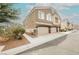 Charming townhome with a two-car garage, neutral stucco, and manicured landscaping at 3312 Speckle Summer Pl # 3, North Las Vegas, NV 89084