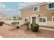 Inviting home exterior with a well-maintained lawn, manicured bushes, and a cozy entryway at 3312 Speckle Summer Pl # 3, North Las Vegas, NV 89084