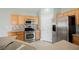 Well-lit kitchen featuring stainless steel appliances, tiled backsplash, light wood cabinets, and neutral countertops at 3312 Speckle Summer Pl # 3, North Las Vegas, NV 89084