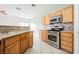 Bright kitchen with stainless steel appliances, tiled backsplash, light wood cabinets, and neutral countertops at 3312 Speckle Summer Pl # 3, North Las Vegas, NV 89084