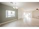 Bright, open-concept living room with tile floors, natural light, and a chandelier at 3312 Speckle Summer Pl # 3, North Las Vegas, NV 89084