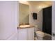 Bathroom featuring a single sink vanity, toilet, and shower with a dark curtain at 35 E Agate Ave # 208, Las Vegas, NV 89123