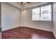 Bedroom featuring hardwood floors, recessed lighting, and a large window at 35 E Agate Ave # 208, Las Vegas, NV 89123