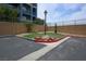 A small dog park with green grass, rocks, and a dog waste station with a bag dispenser at 35 E Agate Ave # 208, Las Vegas, NV 89123