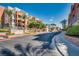 Park Avenue Condominiums entrance featuring mature trees, lush landscaping, and clear signage at 35 E Agate Ave # 208, Las Vegas, NV 89123
