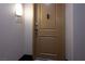 A light-brown front door with a peephole, knob, and room number at 35 E Agate Ave # 208, Las Vegas, NV 89123