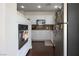 Bright kitchen with stainless steel appliances, white cabinets, and dark hardwood flooring at 35 E Agate Ave # 208, Las Vegas, NV 89123