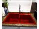 Close up of a red kitchen sink with granite countertops at 35 E Agate Ave # 208, Las Vegas, NV 89123