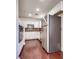 Kitchen with white cabinets, granite counters, stainless appliances and hardwood flooring at 35 E Agate Ave # 208, Las Vegas, NV 89123