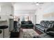 Spacious living room with sleek, modern furniture and large windows at 35 E Agate Ave # 208, Las Vegas, NV 89123