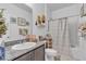 Neutral toned bathroom with gray cabinets, granite counters and shower over tub at 3964 E Marathon Dr, Pahrump, NV 89061