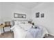 Bright bedroom with a queen bed, side table, decor, and light walls at 3964 E Marathon Dr, Pahrump, NV 89061